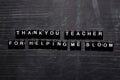 Thank you teacher for helping me bloom on wooden blocks. Education, Motivation and inspiration concept Royalty Free Stock Photo