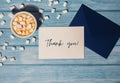 THANK YOU text on grateful card inscription positive quote phrase Greeting card blue envelope with white cup of coffee Royalty Free Stock Photo