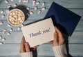 THANK YOU text on gratitude postcard inscription positive quote phrase Female hands holding greeting card blue envelope Royalty Free Stock Photo