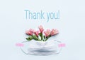 Thank You text with medical mask and pink flowers on blue background. Nurse day or Thanks to doctors concept