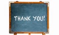 Thank you! text message in white chalk letters written on a school blue old grungy vintage wooden chalkboard or blackboard Royalty Free Stock Photo