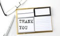 THANK YOU text on sticky notes with glasses and pen, business concept Royalty Free Stock Photo