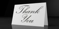 Thank you text on white card, isolated on black background. Royalty Free Stock Photo