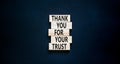 Thank you for trust symbol. Concept words Thank you for your trust on wooden blocks on a beautiful black table black background. Royalty Free Stock Photo