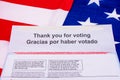 Thank you for voting text and return instructions in English and Spanish languages on election vote by mail envelope. The flag of