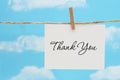 Thank you white greeting card over blue sky