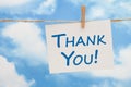 Thank you white greeting card over blue sky