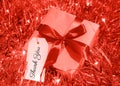 Thank you white tag on Gift box decorated with red bow in Christmas Garland Royalty Free Stock Photo