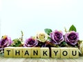 Thank you word wooden block with artificial roses flowers decor Royalty Free Stock Photo
