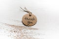 Thank you word written in a card on wooden background. Love and gratitude concept.