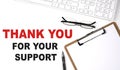 THANK YOU FOR YOUR SUPPORT text written on the white background with keyboard, paper sheet and pen Royalty Free Stock Photo