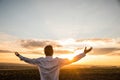 Thankful Businessman with Open Arms at the Field on sunset Royalty Free Stock Photo