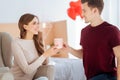 Thankful girl smiling to boyfriend bringing her tea Royalty Free Stock Photo