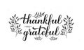 Thankful and Grateful calligraphy hand lettering with floral elements. Thanksgiving Day inspirational quote. Vector template for Royalty Free Stock Photo
