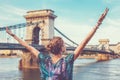 Thankful young redhead woman arms raised at Chain Bridge, Budapest Royalty Free Stock Photo