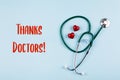 Thanks Doctor Card. Medical stethoscope, two red hearts. Healthcare medicine concept. Flat lay