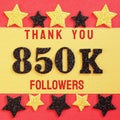 Thanks 850K, 850000 followers. message with black shiny numbers on red and gold background with black and golden shiny stars