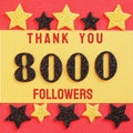 Thanks 8000, 8K, followers. message with black shiny numbers on red and gold background with black and golden shiny stars