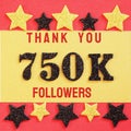 Thanks 750000, 750K followers. message with black shiny numbers on red and gold background with black and golden shiny stars