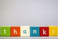 Thanks - word made of colored wooden cubes. Copy space. Close-up.