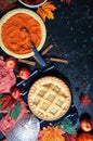 Thanksgiving apple and pumpkin pies on dark marble background.