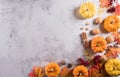 Thanksgiving background concept with fall leaves, pumpkin and seasonal autumnal decor on stone background, top view, copy space