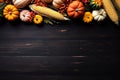 Thanksgiving background corn cob, pumpkins and fallen leaves on a dark wooden table. banner with copy space for text. Halloween, Royalty Free Stock Photo