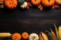 Thanksgiving background corn cob, pumpkins and fallen leaves on a dark wooden table. banner with copy space for text. Halloween, Royalty Free Stock Photo