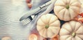 Thanksgiving background. Holiday scene. Wooden table, decorated with pumpkins, autumn leaves