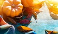 Thanksgiving background with Pumpkins, autumn leaves and warm blanket on wooden table