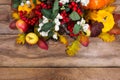 Thanksgiving background with rowan, apples, yellow squash, oak l Royalty Free Stock Photo