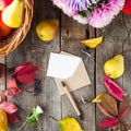 Thanksgiving background with seasonal fruits, flowers, greeting card and envelope on a rustic wooden table. Autumn harvest concept Royalty Free Stock Photo