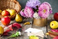 Thanksgiving background with seasonal fruits, flowers, greeting card and envelope on a rustic wooden table. Autumn harvest concept Royalty Free Stock Photo