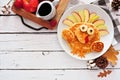 Thanksgiving breakfast with turkey pancakes, top view corner border against a white wood background Royalty Free Stock Photo