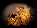 Thanksgiving cornucopia centerpiece with porcelain pumpkin pitcher, scarecrow, sunflowers and oak leaves celebrating fall autumn h Royalty Free Stock Photo