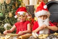 Thanksgiving day and Christmas for children. Funny Kids in kitchen making christmas cookies. Cookies for Santa Claus