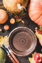 Thanksgiving day concept. Autumn table setting for dinner with plate, knife, fork decorated pumpkins and maple leaves. Flat lay Royalty Free Stock Photo