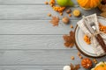 Thanksgiving day concept. Top view photo of plate knife fork napkin maple leaves raw vegetables pumpkins pear walnut rowan berries