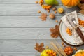 Thanksgiving day concept. Top view photo of plate knife fork napkin maple leaves raw vegetables pumpkins pear wheat walnut rowan