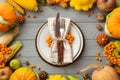 Thanksgiving day concept.. Top view photo of plate knife fork napkin vegetables pumpkins maize pattypans zucchini apples pears Royalty Free Stock Photo