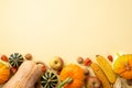 Thanksgiving day concept. Top view photo of raw vegetables pumpkins gourd apples corn walnuts and physalis on isolated beige