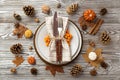 Thanksgiving Day Concept.. Top View Photo Of Table Setting Plate Knife Fork Napkin Rowan Small Pumpkins Pine Cones Acorns Anise