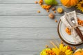 Thanksgiving day concept. Top view photo of table setting plate knife fork napkin sunflowers vegetables pumpkins pear wheat walnut