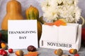 Thanksgiving day, holiday celebrated every fourth Thursday in November. Autumn composition with wooden block calendar and paper