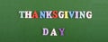 THANKSGIVING DAY word on green background composed from colorful abc alphabet block wooden letters, copy space for ad text. Royalty Free Stock Photo