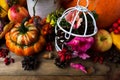 Thanksgiving decor with orange turban squash and birdcage