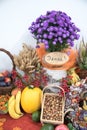 Thanksgiving decoration with fruits, wheat and flowers, wooden tree slice with german word DANKE