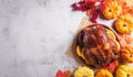 Thanksgiving dinner background concept with turkey roasted and all sides dishes, fall leaves, pumpkin and seasonal autumnal decor