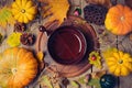 Thanksgiving dinner background with plate. Autumn pumpkin and fall leaves on wooden table.