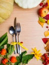 Thanksgiving dinner background with pumpkins, fall leaves, table setting, physalis, apple, top view, copy space Royalty Free Stock Photo